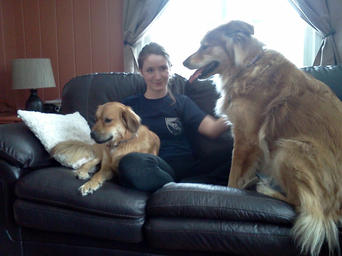 Sarah relaxing on the couch with Chase and Kaya